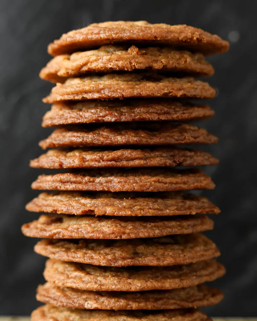 several crispy brown butter chocolate chip cookies in a large stack that takes up the whole photo
