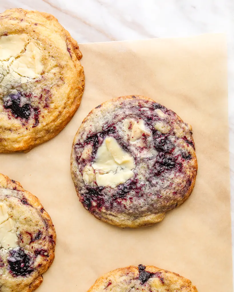 blueberry white chocolate cookies on a piece of parchment paper