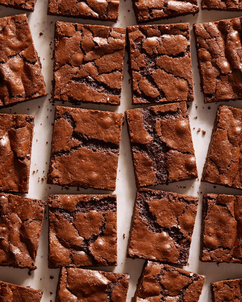 thin chewy brownies with a shiny, crackly top surrounded by other brownies