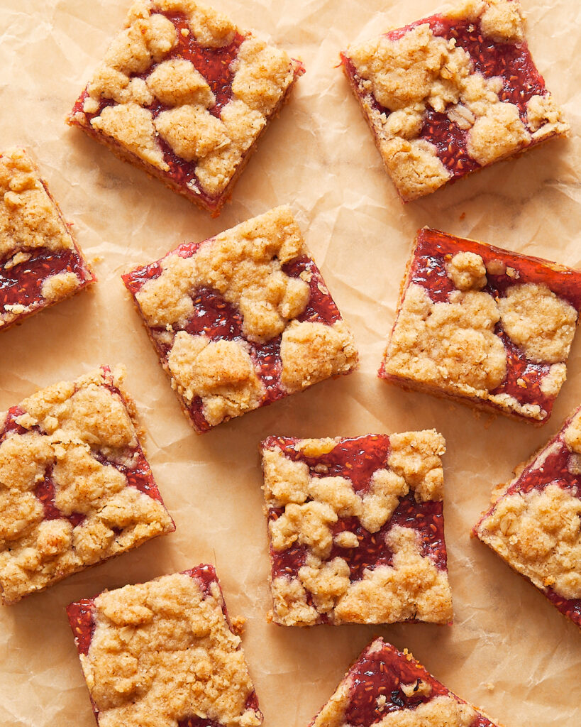 Slices of oat raspberry bars arranged on parchment paper