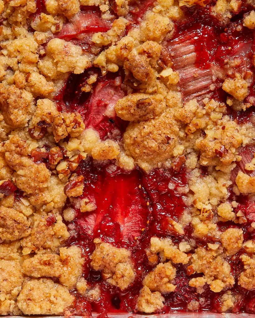 a close-up on the top of a vegan strawberry rhubarb crumble