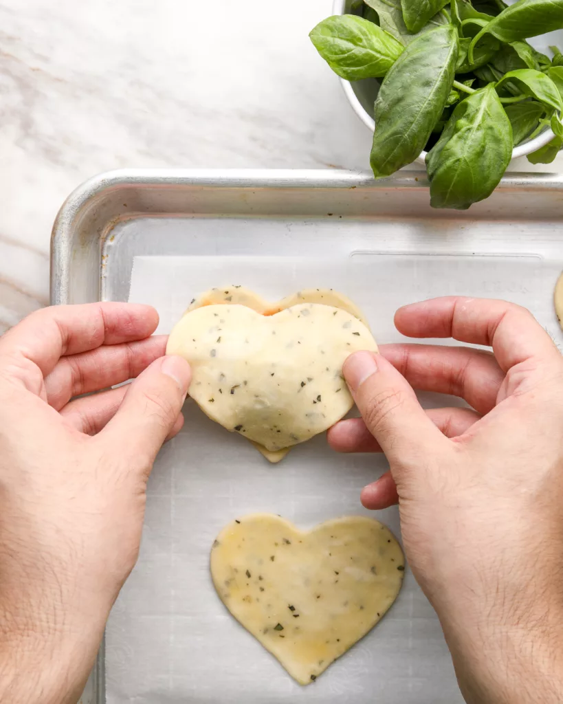 The top crust of the hand pie is placed on top of the filling