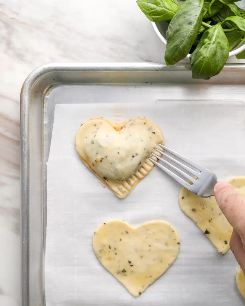 The top and bottom crusts of the hand pie are crimped together with a fork