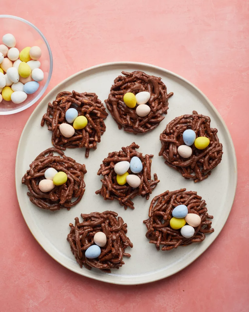 chocolate no-bake easter birds nest cookies with chocolate eggs on white serving plate