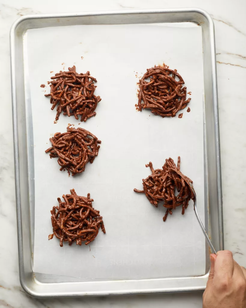 chocolate no-bake easter birds nest cookies on a sheet tray lined with parchment