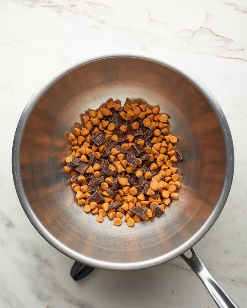 a bowl of butterscotch chips and chocolate and set over a double boiler