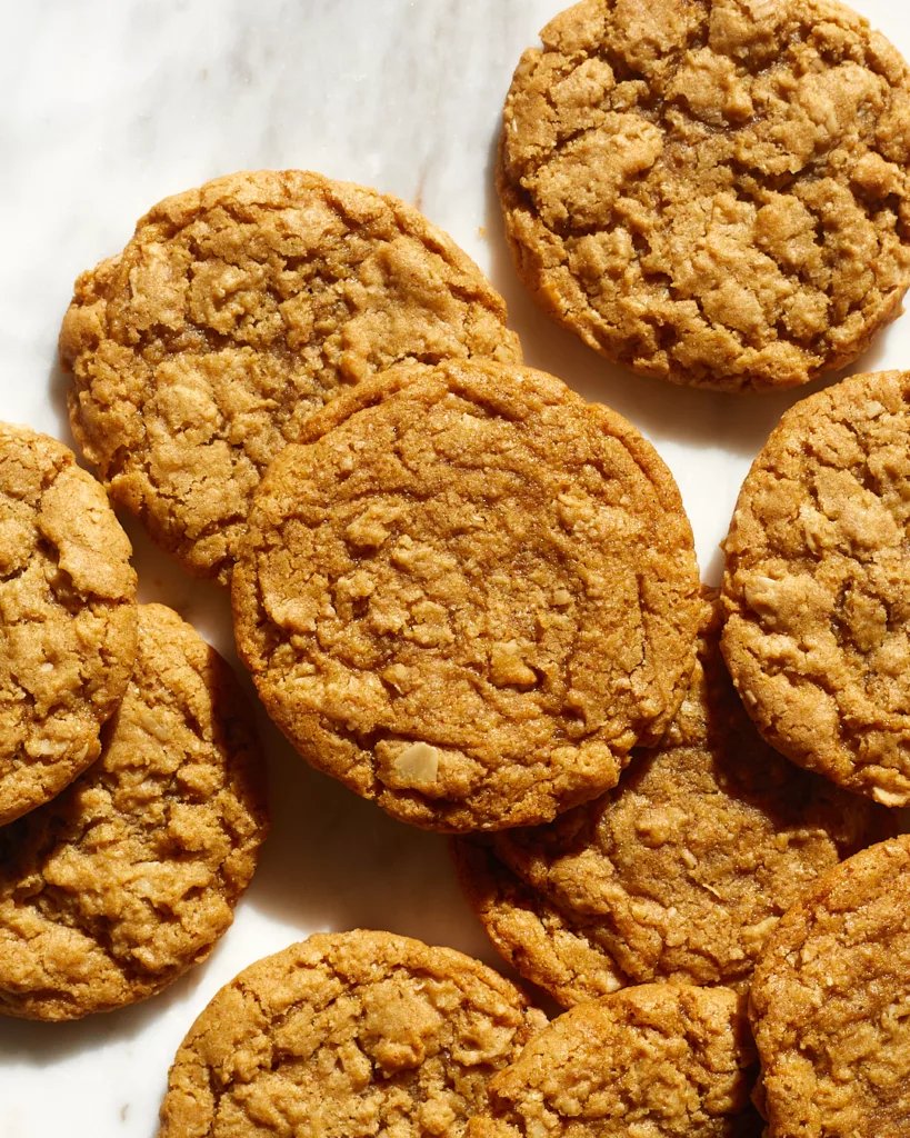 oatmeal cookies are scattered on a white marble background