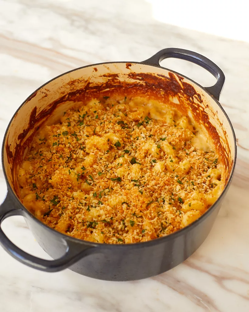 a dutch oven full of baked. 4-cheese mac and cheese with breadcrumb topping