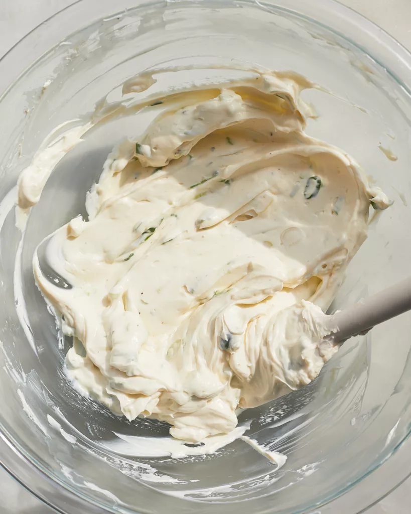 scallion cream cheese filling being mixed in a bowl