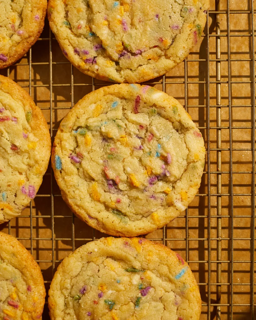 rainbow sprinkle confetti funfetti cookies on a cooling rack