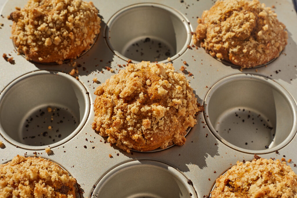 pumpkin coffee cake muffins in a tin