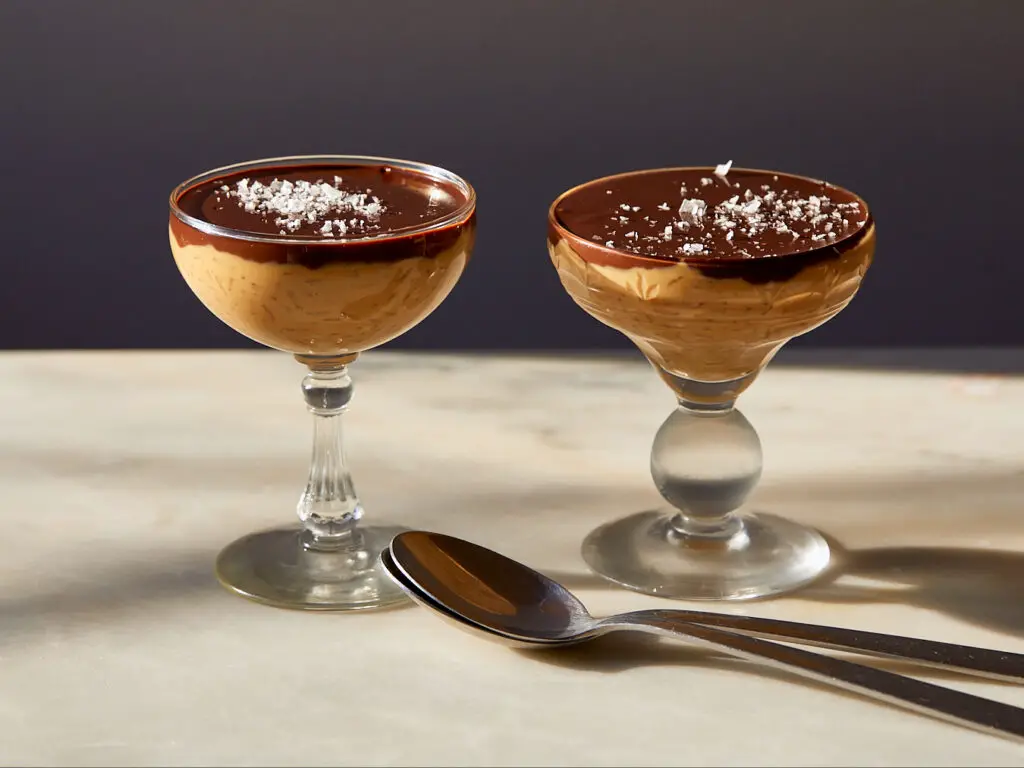 caramel rice pudding with chocolate ganache topping in two crystal glasses
