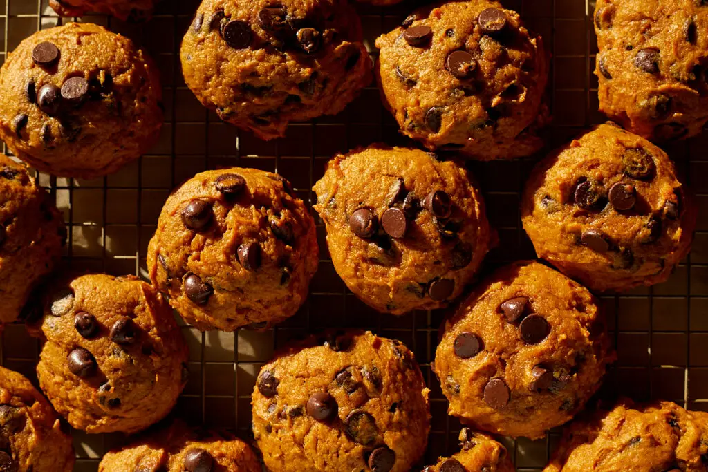 pumpkin chocolate chip cookies on a wire rack