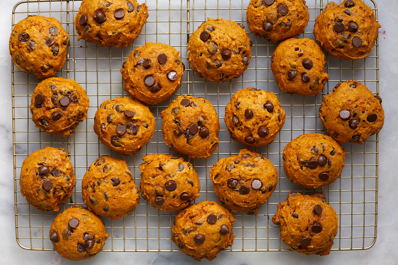 pumpkin chocolate chip cookies on a wire rack