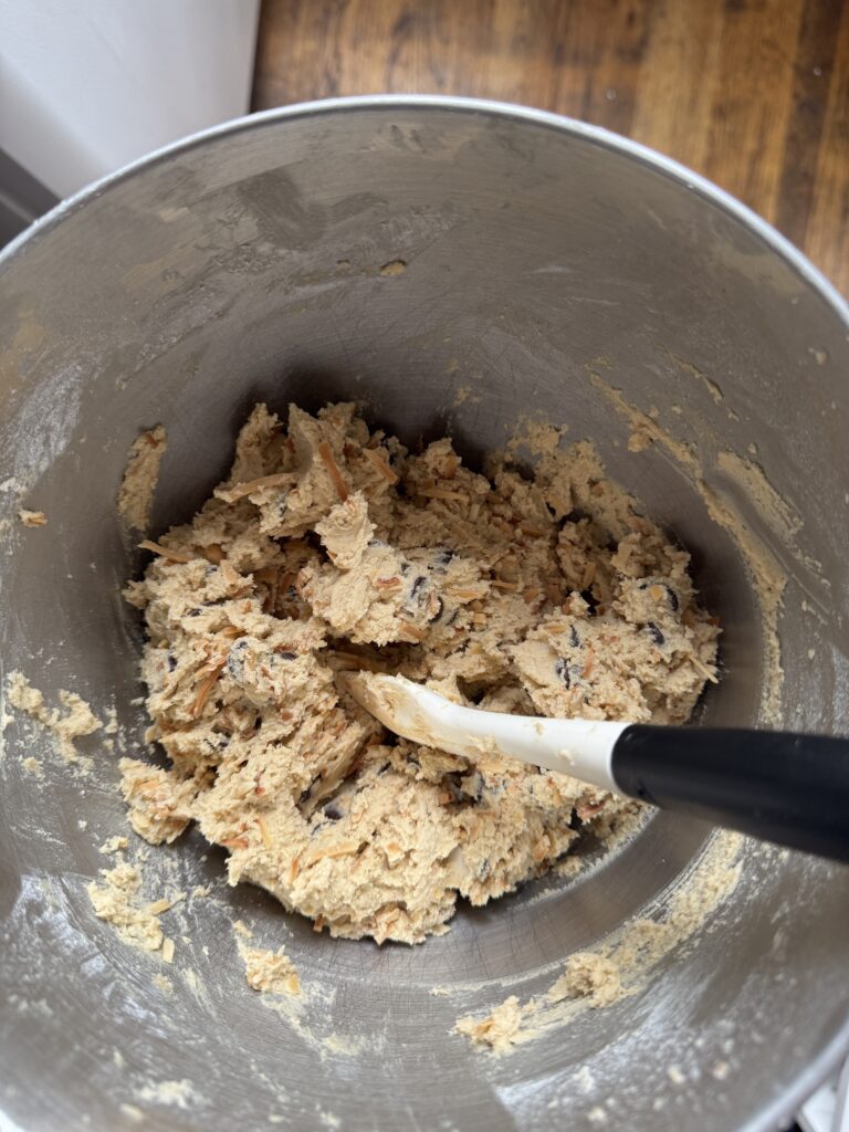 a bowl of cookie dough with a rubber spatula