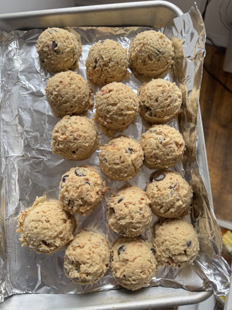 balls of cookie dough on a baking sheet lined with foil