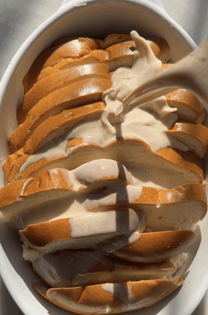 custard being poured over bread slices