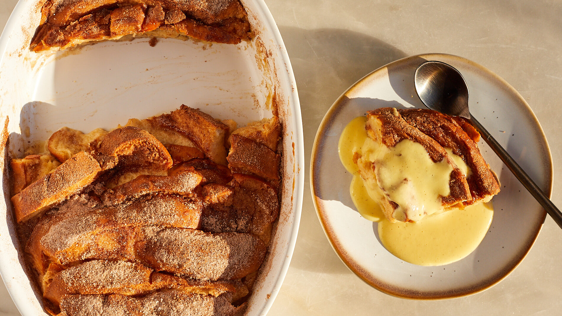 A slice of eggnog french toast bake with eggnog creme anglaise poured on top