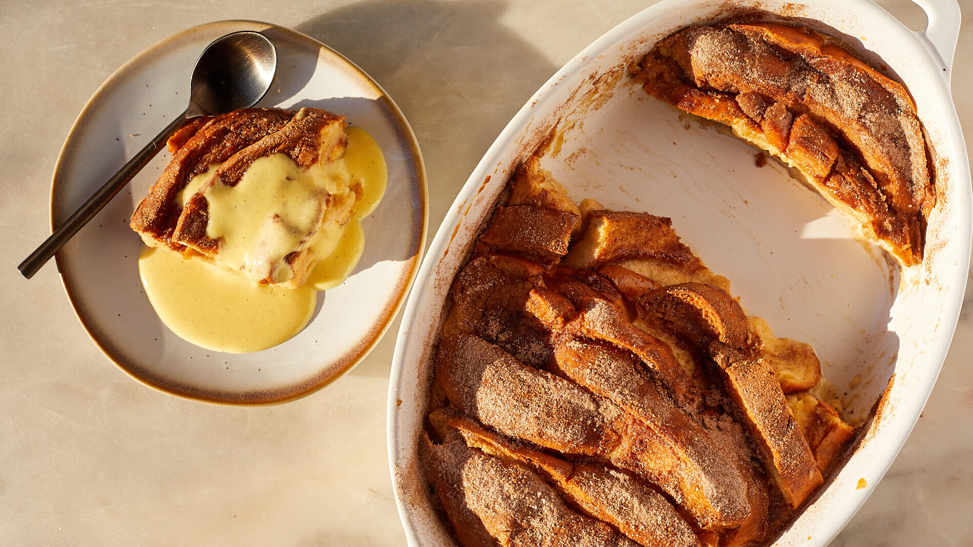 A slice of eggnog french toast bake with eggnog creme anglaise poured on top