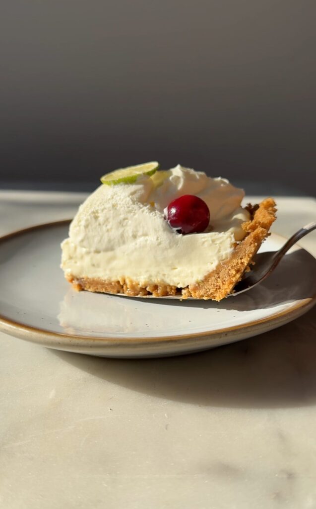 A slice of No-Bake Key Lime Cheesecake on a dessert plate